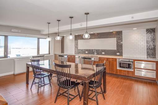 a club house with a table and chairs and a kitchen at 10 West Apartments, New York 11561