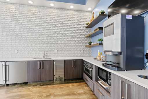 a kitchen with white countertops and gray cabinets