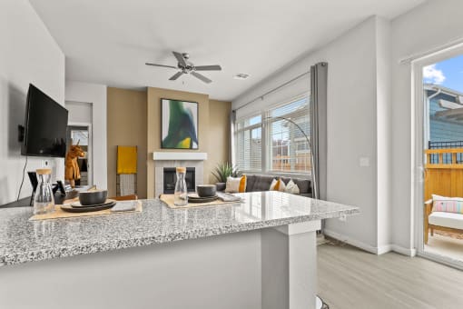 a kitchen and living room with a fireplace at The Villas at Prairie Center, Brighton, Colorado