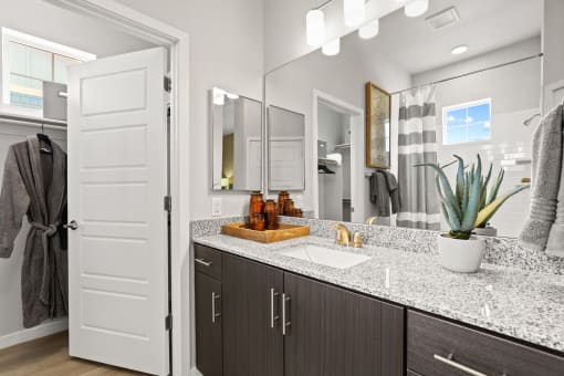 a bathroom with a sink and a mirror at The Villas at Prairie Center, Brighton
