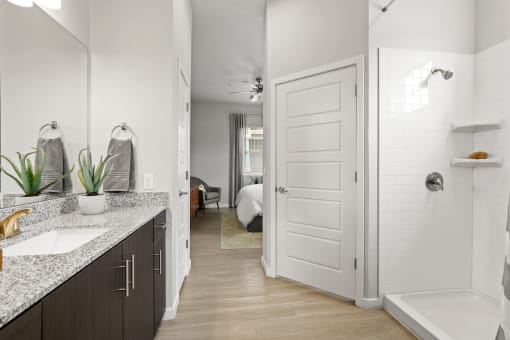 a bathroom with a sink and a bathtub in a 555 waverly unit at The Villas at Prairie Center, Brighton, 80601