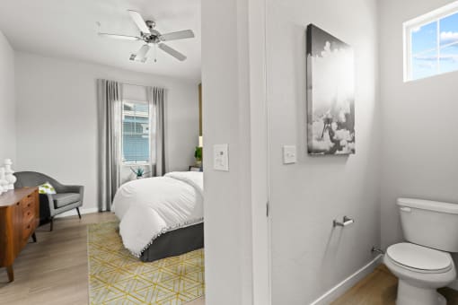 a bedroom with a bed and a ceiling fan in a 555 waverly unit at The Villas at Prairie Center, Brighton, 80601