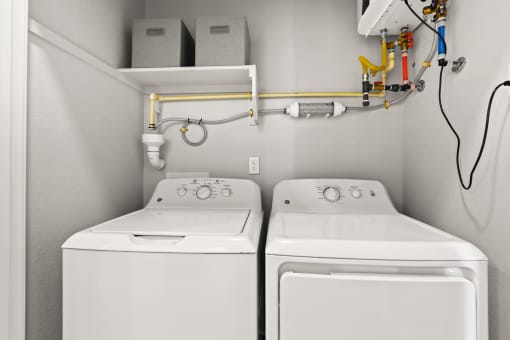 a washer and dryer in a laundry room at The Villas at Prairie Center, Colorado, 80601