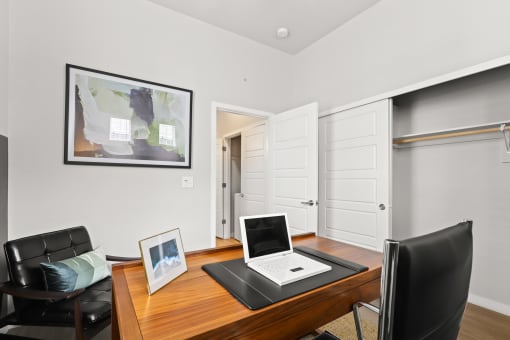 a desk with a laptop and a laptop computer on top of it at The Villas at Prairie Center, Brighton, CO