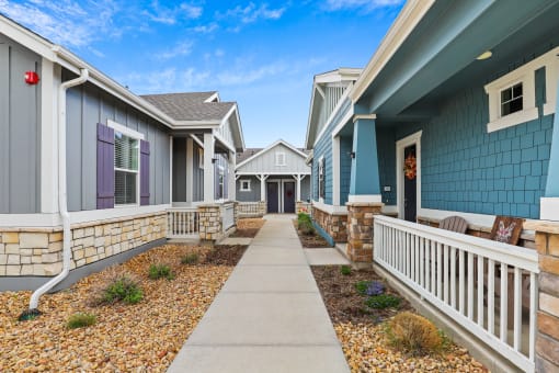 a row of houses with blue and purple siding at The Villas at Prairie Center, Brighton, Colorado