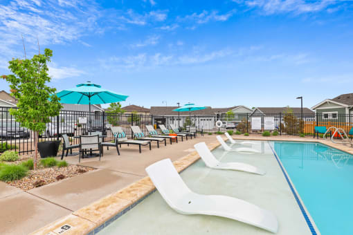 the reserve at bucklin hill leasing office pool with lounge chairs and umbrellas at The Villas at Prairie Center, Brighton, 80601