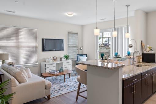 an open floor plan with a kitchen and living room at Cirrus Apartments, Ashland, Massachusetts