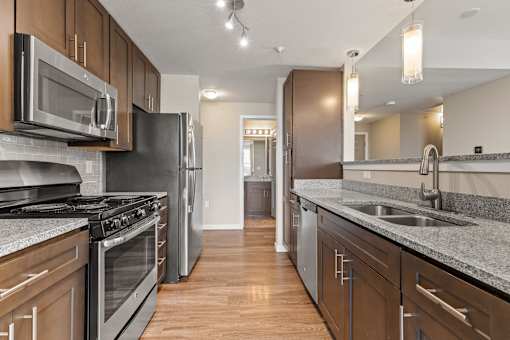 a kitchen with stainless steel appliances and granite countertops