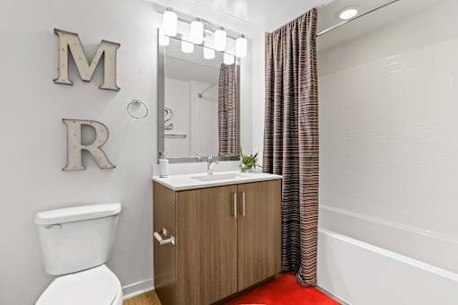 a bathroom with a toilet sink and bathtub at 8000 Uptown Apartments, Colorado