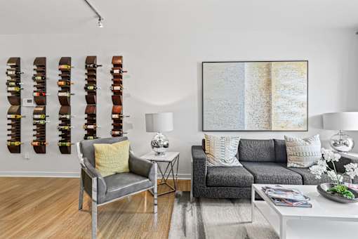 a living room filled with furniture and a large painting on a wall at 8000 Uptown Apartments, Broomfield, CO, 80021