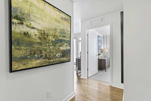 a hallway with a large painting on the wall at 8000 Uptown Apartments, Broomfield, 80021