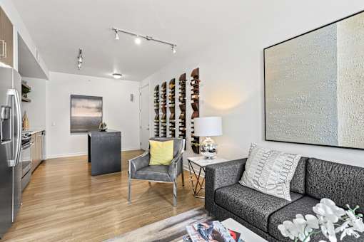 a living room with a couch and two chairs at 8000 Uptown Apartments, Broomfield, CO