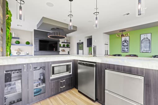 a kitchen with gray cabinets and green walls