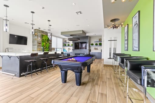 a game room with a pool table and bar