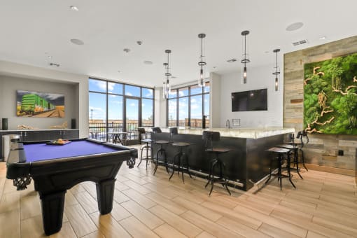 a large room with a pool table and a bar