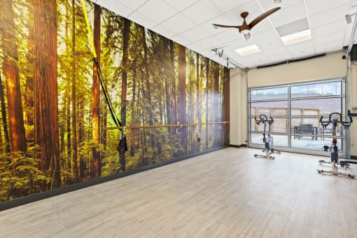 a yoga studio with a large mural of a forest