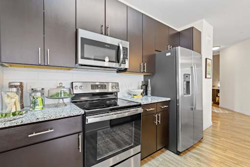 a modern kitchen with stainless steel appliances and a stainless steel refrigerator