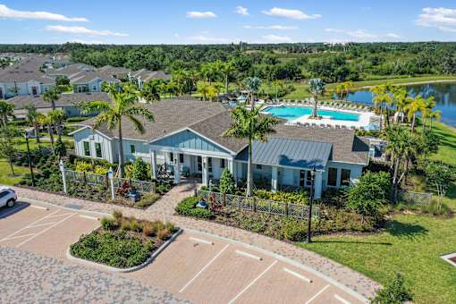 an aerial view of a house with a swimming pool and tennis court at Artesia at Lakewood Ranch Apartments, Bradenton
