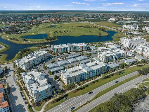 A bird's eye view of a residential area with a large lake in the foreground. at Centre Pointe Apartments, Melbourne