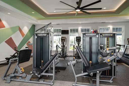 a gym with treadmills and other exercise equipment in a hotel room at Artesia at Lakewood Ranch Apartments, Florida 34211