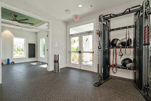a home gym with weights and a door to a patio at Artesia at Lakewood Ranch Apartments, Bradenton, 34211