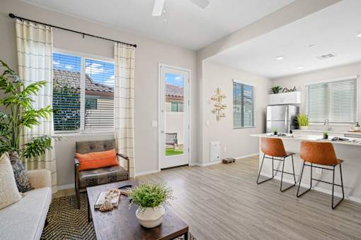 a living room with a dining area and a kitchen with a table and chairs at Soleil at Canyon Trails Apartments, Arizona, 85338