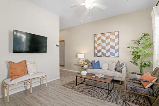 a living room with a couch and a table at Soleil at Canyon Trails Apartments, Goodyear