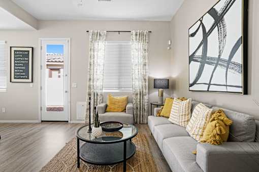 a living room with a couch and a coffee table at Soleil at Canyon Trails Apartments, Goodyear, Arizona