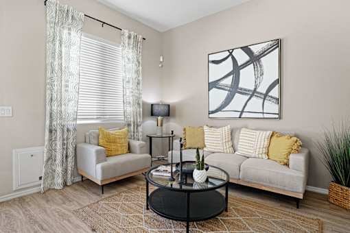 a living room with a couch and a coffee table at Soleil at Canyon Trails Apartments, Goodyear, AZ, 85338