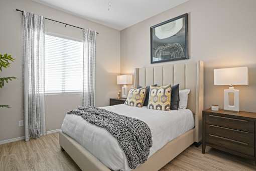 an overview of a bedroom with a bed and a window at Soleil at Canyon Trails Apartments, Arizona