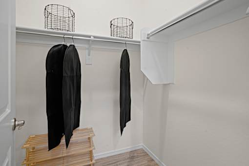 a closet with wooden steps and a black jacket hanging on the wall at Soleil at Canyon Trails Apartments, Goodyear, AZ, 85338