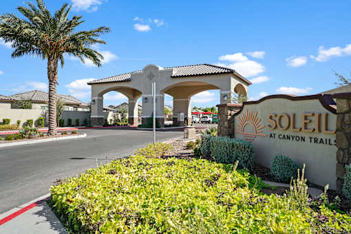 a sign for solstice at canyon trail sits in front of a building at Soleil at Canyon Trails Apartments, Goodyear, AZ, 85338