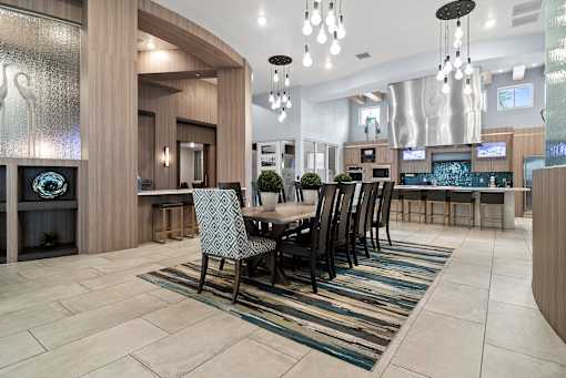 A modern dining room with a large table and chairs. at Centre Pointe Apartments, Melbourne, Florida