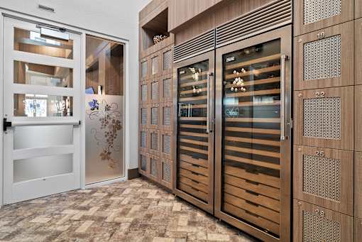 A set of wooden doors with glass panels and decorative designs. at Centre Pointe Apartments, Melbourne