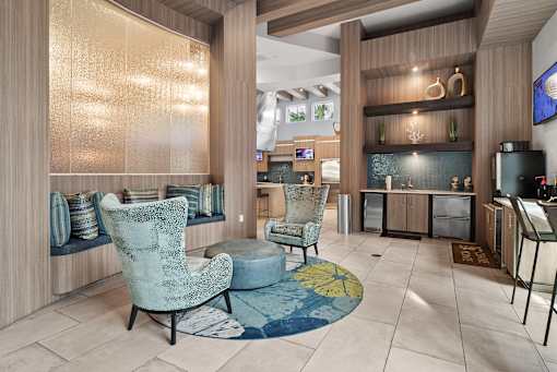 A living room with a blue chair and ottoman.