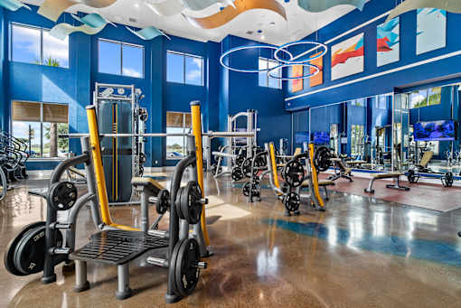 A gym with a variety of exercise equipment including treadmills, stationary bikes, and weight machines. at Centre Pointe Apartments, Melbourne, 32940