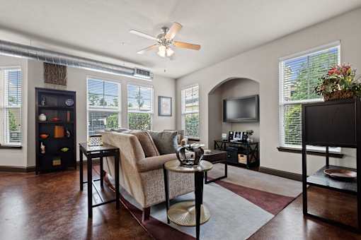 a living room with a couch and a tv at The Millennium Towne Center Apartments, Louisiana