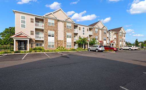 an empty parking lot in front of an apartment building at The Landing Apartment , Hazlet, New Jersey