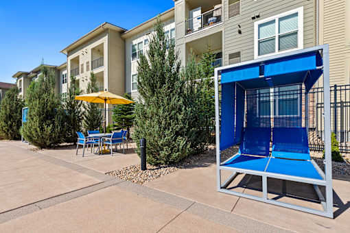 our apartments have a patio with a tennis court and tables