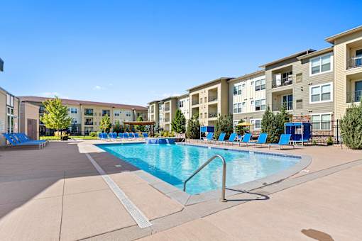 our apartments offer a swimming pool with an apartment building in the background
