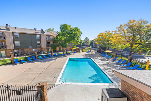 our apartments have a resort style pool with lounge chairs at Silver Reef Apartments, Lakewood, Colorado