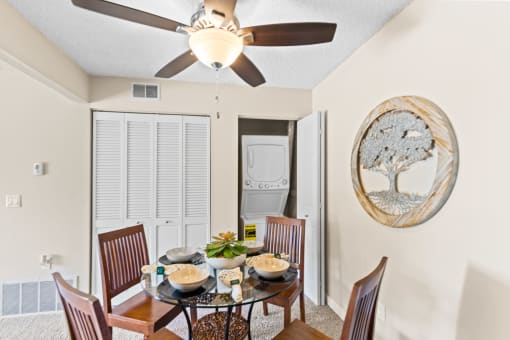 a dining room with a table and chairs and a ceiling fan at Silver Reef Apartments, Colorado