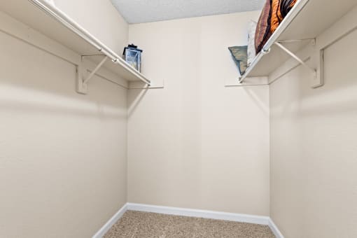 a spacious closet in a bedroom with white walls and shelves at Silver Reef Apartments, Lakewood, CO, 80228