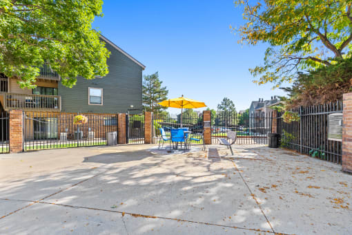 our yard is big and has a table and chairs with an umbrella at Silver Reef Apartments, Lakewood, CO, 80228