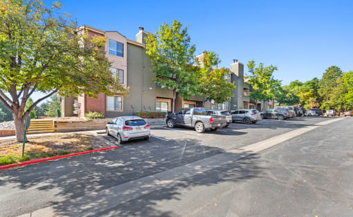 a parking lot with cars parked in front of apartment buildings at Silver Reef Apartments, Lakewood, 80228