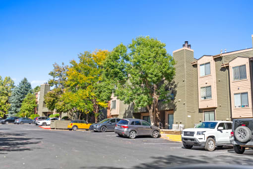a parking lot with cars in front of an apartment building at Silver Reef Apartments, Lakewood, CO, 80228
