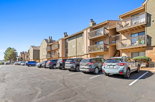 a row of cars parked in front of an apartment building at Silver Reef Apartments, Lakewood, CO, 80228