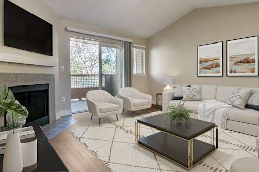 a living room with a couch chair coffee table and fireplace