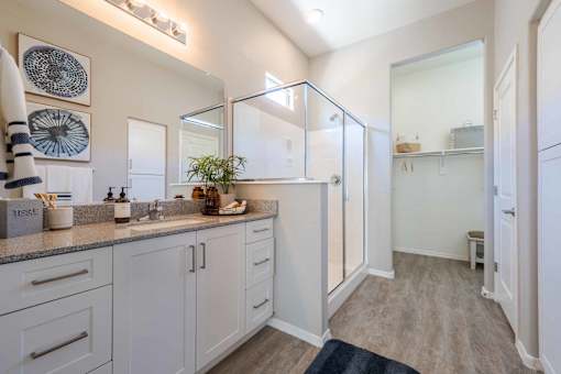 A kitchen with white cabinets and a grey countertop. at Vistoria At Marley Park Apartments, Surprise, Arizona
