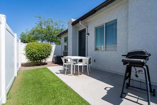 Private patio with outdoor dining and grill at Vistoria On Mountain View Apartments, Surprise